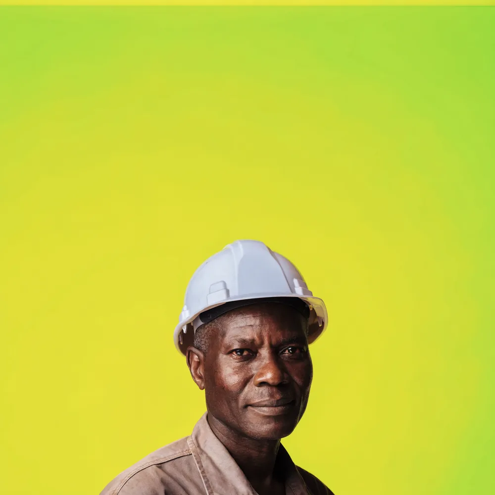 A man in a hard hat against a volt background